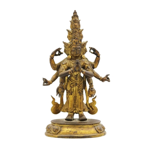 82 - A Sino-Tibetan gilt bronze figure of Avalokitesvara, 18th/19th century. Standing with eight arms and... 