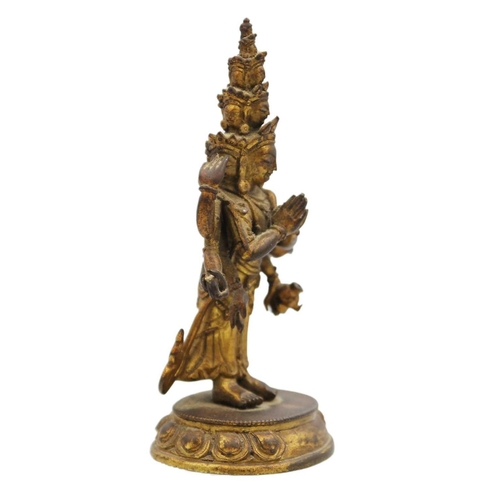 82 - A Sino-Tibetan gilt bronze figure of Avalokitesvara, 18th/19th century. Standing with eight arms and... 