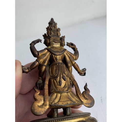 82 - A Sino-Tibetan gilt bronze figure of Avalokitesvara, 18th/19th century. Standing with eight arms and... 