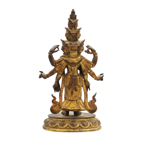 82 - A Sino-Tibetan gilt bronze figure of Avalokitesvara, 18th/19th century. Standing with eight arms and... 