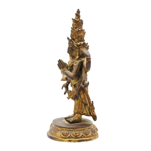 82 - A Sino-Tibetan gilt bronze figure of Avalokitesvara, 18th/19th century. Standing with eight arms and... 