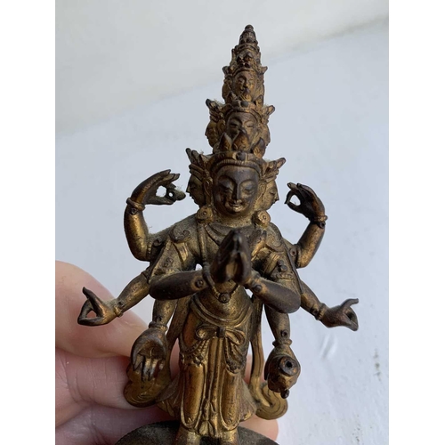 82 - A Sino-Tibetan gilt bronze figure of Avalokitesvara, 18th/19th century. Standing with eight arms and... 