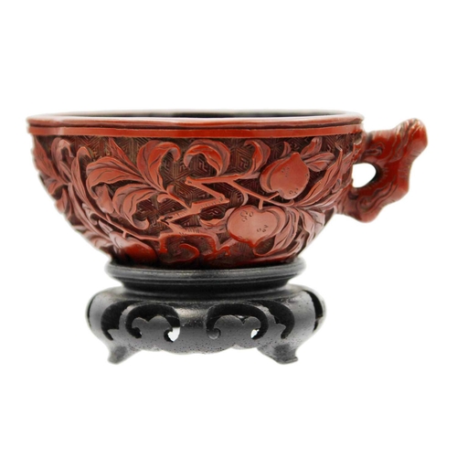 88 - A Chinese cinnabar lacquer libation cup, Qing Dynasty, 18th/19th century Carved with branches of fru... 