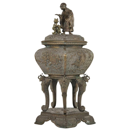 89 - A large Japanese bronze koro, signed. The cover surmounted by a man in robes above the model of an i... 