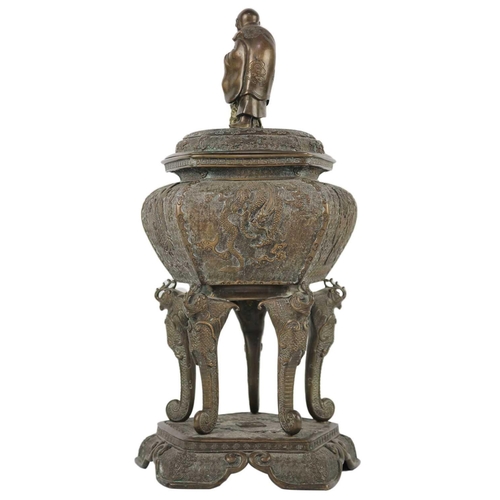 89 - A large Japanese bronze koro, signed. The cover surmounted by a man in robes above the model of an i... 