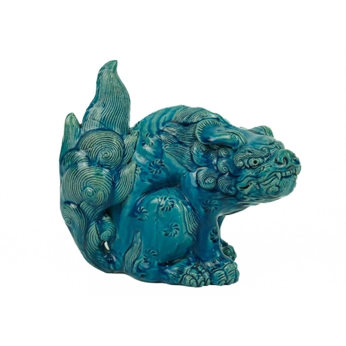 9 - A Chinese turquoise glazed pottery 'Lion' dog, circa 1900, late Qing Dynasty. The mythical beast in ... 