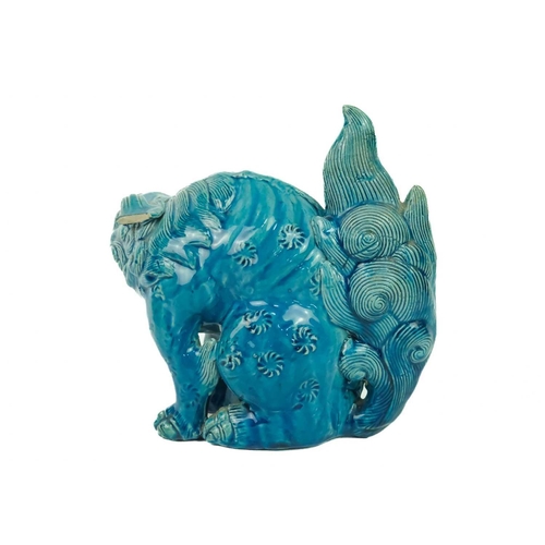 9 - A Chinese turquoise glazed pottery 'Lion' dog, circa 1900, late Qing Dynasty. The mythical beast in ... 