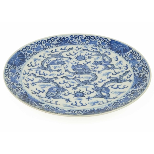 97 - A Chinese blue and white porcelain plate, Qianlong period, 18th century. With five dragons chasing t... 