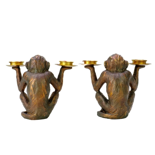 110 - A pair of resin tealight holders modelled as seated monkeys. Height 18cm. No condition issues.