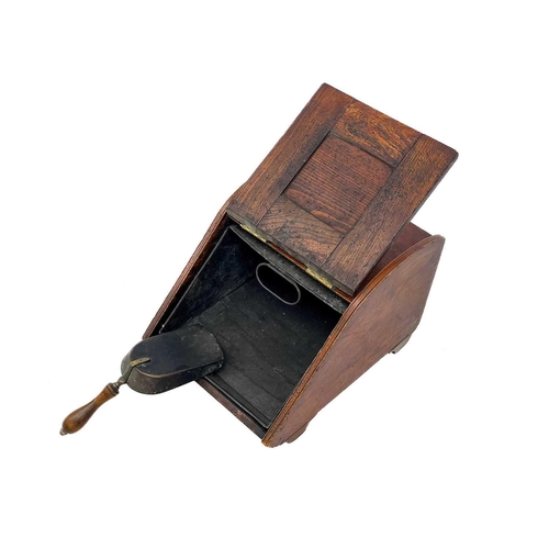 114 - A late Victorian aesthetic movement elm and brass coal scuttle. With inset square brass panel and ga... 