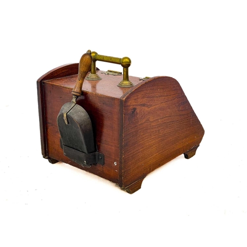 114 - A late Victorian aesthetic movement elm and brass coal scuttle. With inset square brass panel and ga... 