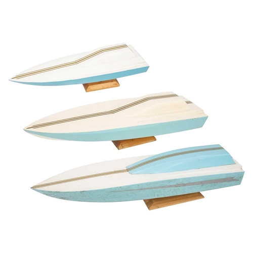 132 - Three graduating painted wood power boat models. Largest length 86cm. (3)