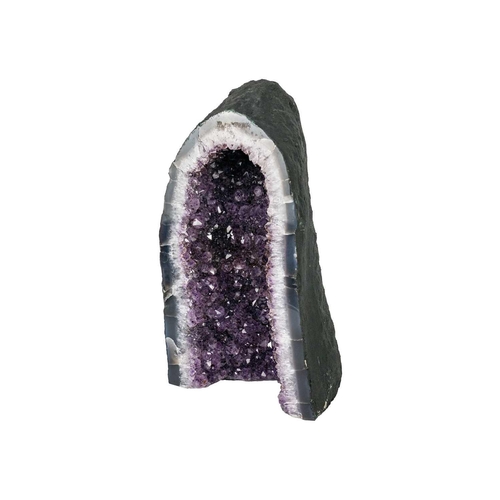 137 - A large free standing 'cathedral' amethyst geode. Vibrant purple in colour, with a flat base, prepar... 