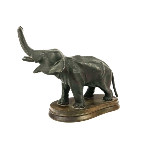 152 - A spelter figure of an Indian elephant. On oval oak base, height 20cm.