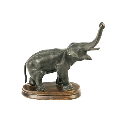 152 - A spelter figure of an Indian elephant. On oval oak base, height 20cm.