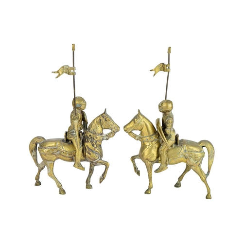 155 - A pair of brass knights on horseback. Height 32cm.