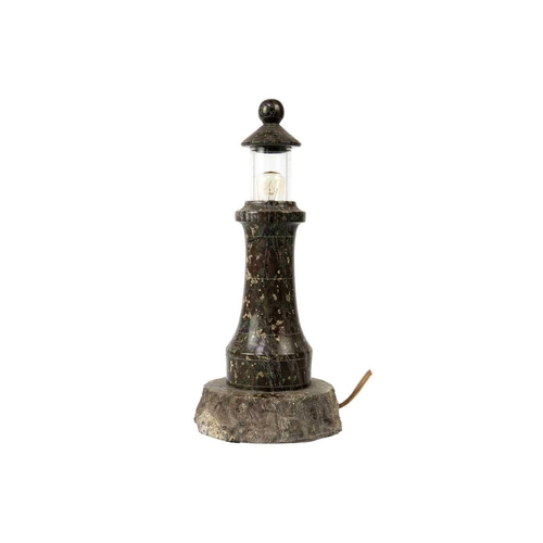 158 - A Cornish serpentine turned lighthouse table lamp. With a glazed top and rockwork base, height 31cm.... 