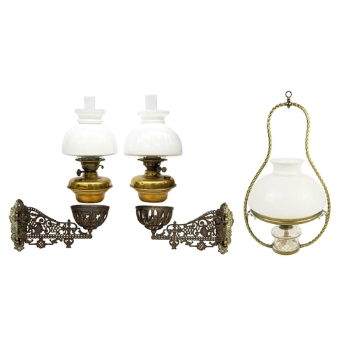 166 - A pair of late Victorian Aesthetic movement cast iron and brass oil wall lights. With hinged brass m... 