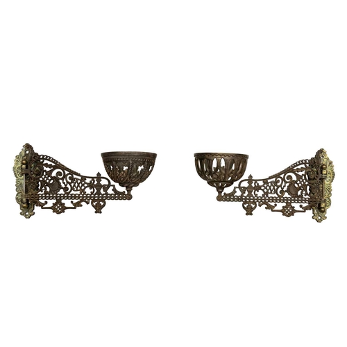 166 - A pair of late Victorian Aesthetic movement cast iron and brass oil wall lights. With hinged brass m... 