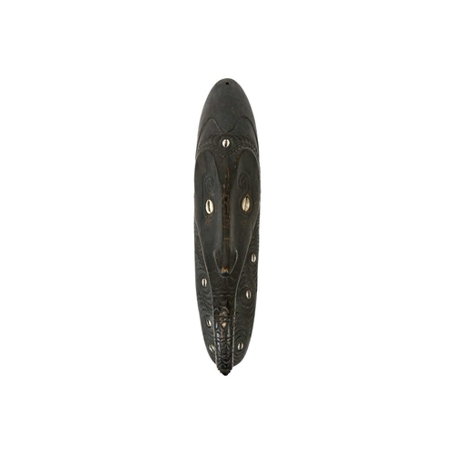 181 - A Papua New Guinea Iatmul or Mei mask. Inlaid with cowrie shells, length 41cm. Maurice Jenkins (1933... 