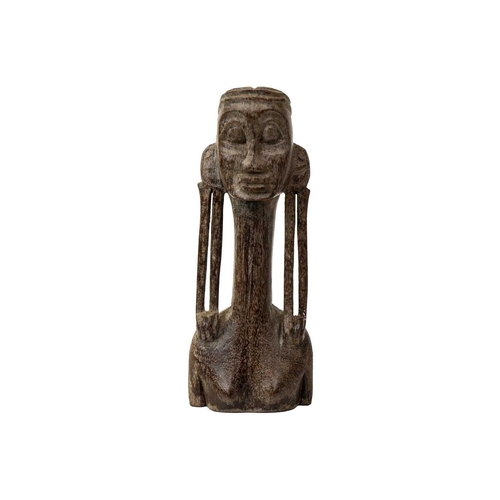 183 - An Oceania wood carved figure with an elongated neck and lobe gauged ears. Height 15cm. Maurice Jenk... 