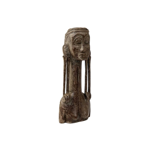 183 - An Oceania wood carved figure with an elongated neck and lobe gauged ears. Height 15cm. Maurice Jenk... 