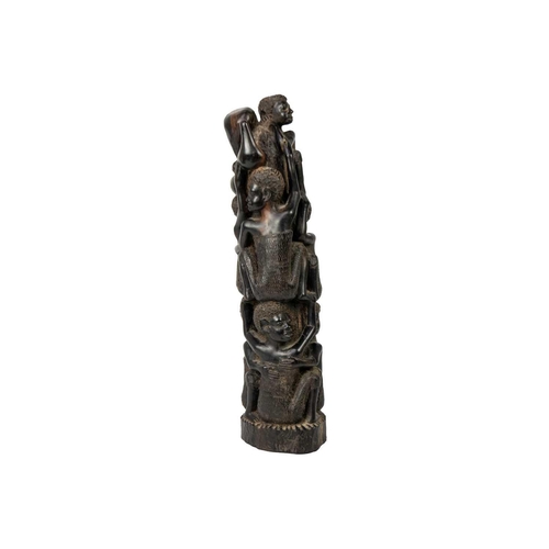 189 - An African hardwood carving group. Decorated with climbing figures, height 40cm. Maurice Jenkins (19... 