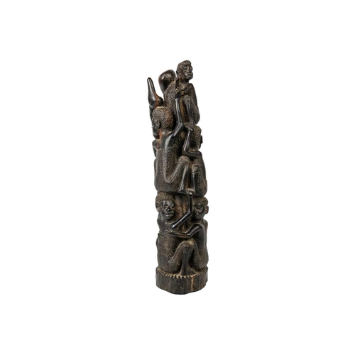 189 - An African hardwood carving group. Decorated with climbing figures, height 40cm. Maurice Jenkins (19... 