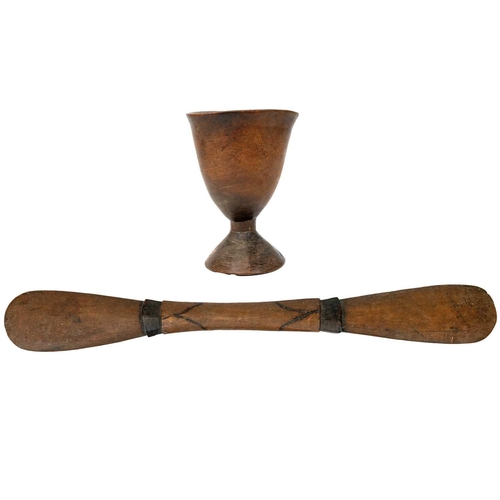 191 - An African carved chalice or libation cup. Height 19cm. Together with a wood carved implement possib... 