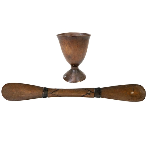 191 - An African carved chalice or libation cup. Height 19cm. Together with a wood carved implement possib... 