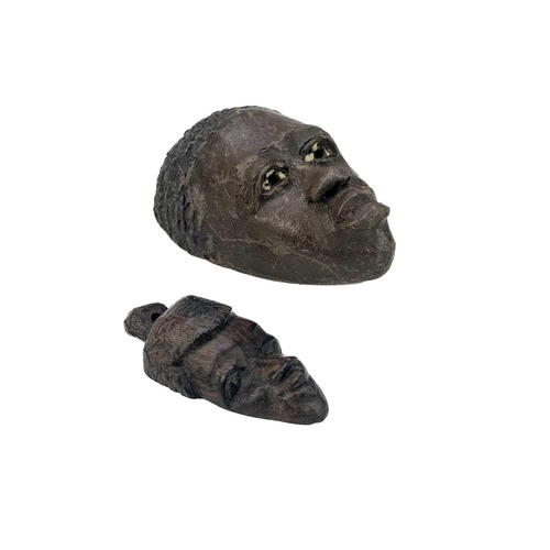 194 - An African carved wood carved mask. Probably Cameroon, with bone teeth, inflated cheeks and remnants... 