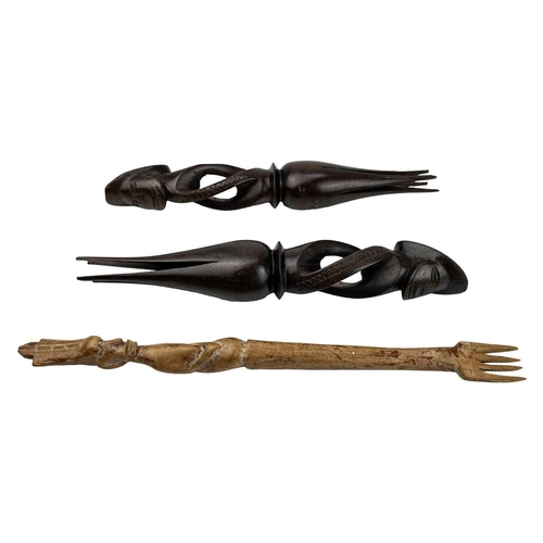 195 - A pair of Fijian cannibal forks. Carved in hardwood, length 32cm together with another carved fork. ... 