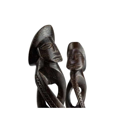 195 - A pair of Fijian cannibal forks. Carved in hardwood, length 32cm together with another carved fork. ... 