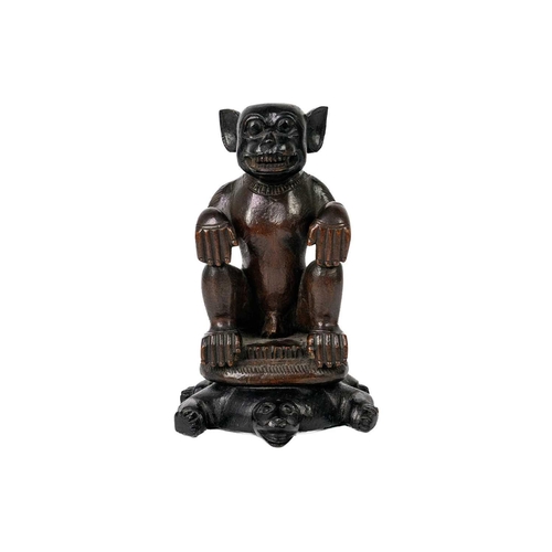 196 - A hardwood monkey sat on a tortoise. Finely carved sat on a lotus leaf plinth atop a tortoise, heigh... 