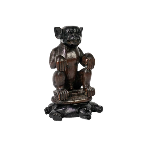 196 - A hardwood monkey sat on a tortoise. Finely carved sat on a lotus leaf plinth atop a tortoise, heigh... 