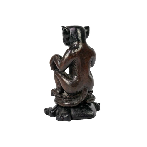 196 - A hardwood monkey sat on a tortoise. Finely carved sat on a lotus leaf plinth atop a tortoise, heigh... 