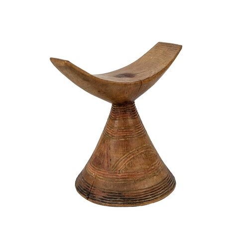 201 - An East African headrest Gurage. The curved top on conical base carved with geometric designs, heigh... 