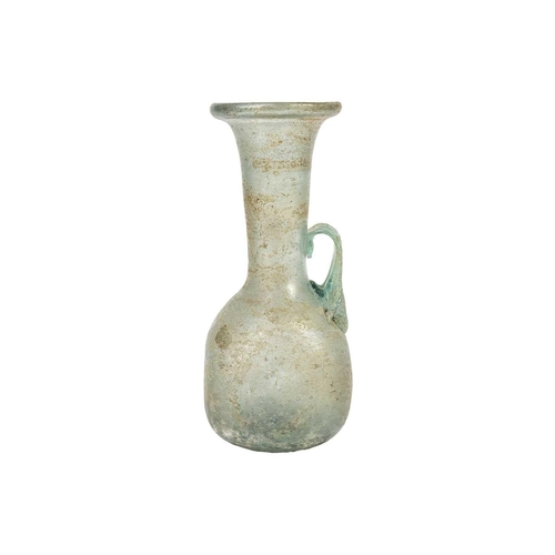 21 - An iridescent green glass vessel. Possibly Roman with folded rim and applied single handle, height 1... 