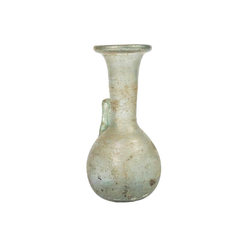 21 - An iridescent green glass vessel. Possibly Roman with folded rim and applied single handle, height 1... 