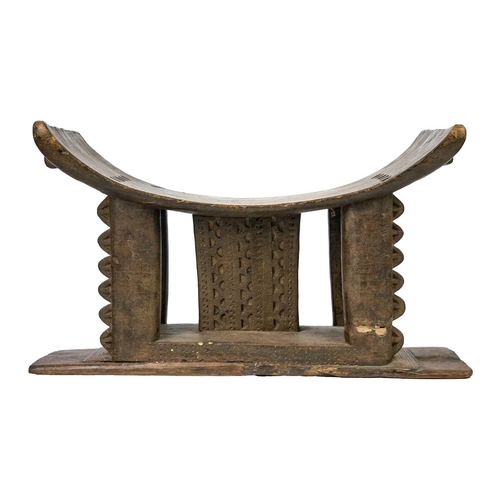 212 - A 19th century Ashanti stool. Of typical form, height 33cm width 53cm depth 27.5cm. Maurice Jenkins ... 