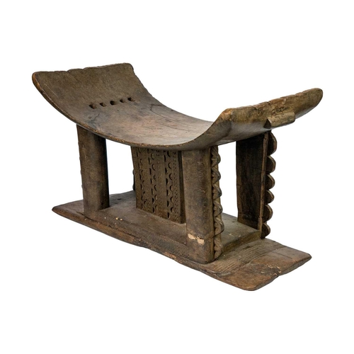 212 - A 19th century Ashanti stool. Of typical form, height 33cm width 53cm depth 27.5cm. Maurice Jenkins ... 