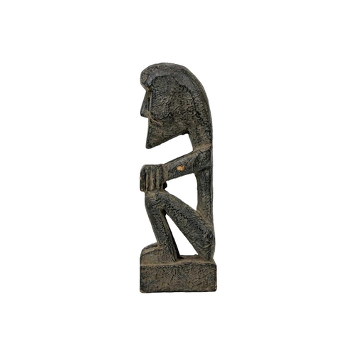 214 - A wood carved ancestor figure. Arms folded sat on their haunches, height 20.5cm. Maurice Jenkins (19... 