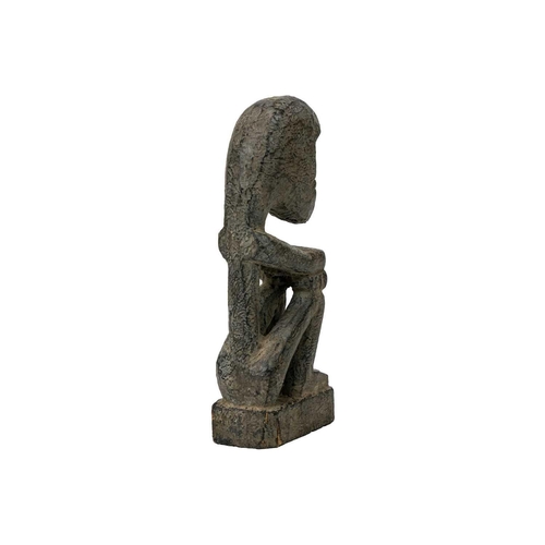 214 - A wood carved ancestor figure. Arms folded sat on their haunches, height 20.5cm. Maurice Jenkins (19... 