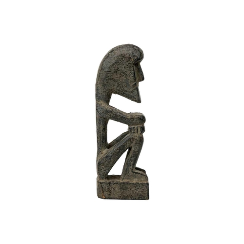 214 - A wood carved ancestor figure. Arms folded sat on their haunches, height 20.5cm. Maurice Jenkins (19... 