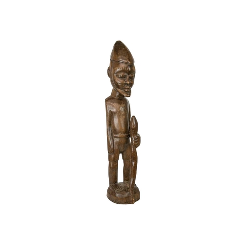 215 - A large African wood carved standing figure. Modelled holding a snake, height 84cm. Maurice Jenkins ... 