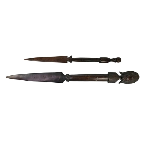 219 - An African wooden spear. Carved with a male head, length 62cm together with another wooden spear. (2... 