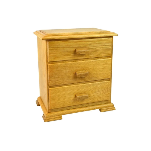 22 - Prenntek Designs. An oak jewellery box in the form of a chest of drawers With top false drawer under... 