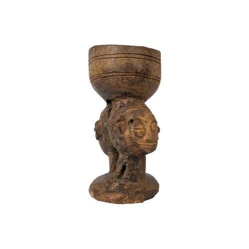 220 - An African carved libation cup possibly Kuba With two headed stem, height 18cm. Maurice Jenkins (193... 