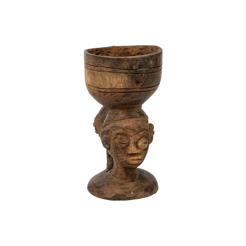 220 - An African carved libation cup possibly Kuba With two headed stem, height 18cm. Maurice Jenkins (193... 