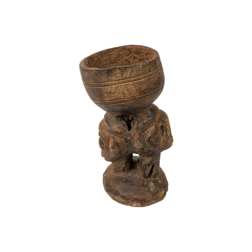 220 - An African carved libation cup possibly Kuba With two headed stem, height 18cm. Maurice Jenkins (193... 